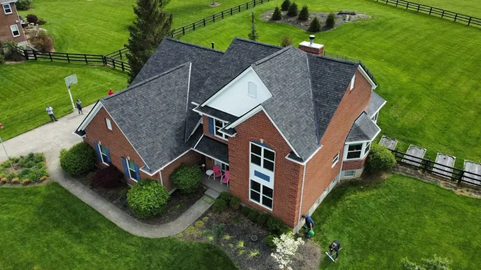 Aerial view of a new shingle roof on a brick home with a glass gable in Cincinnati