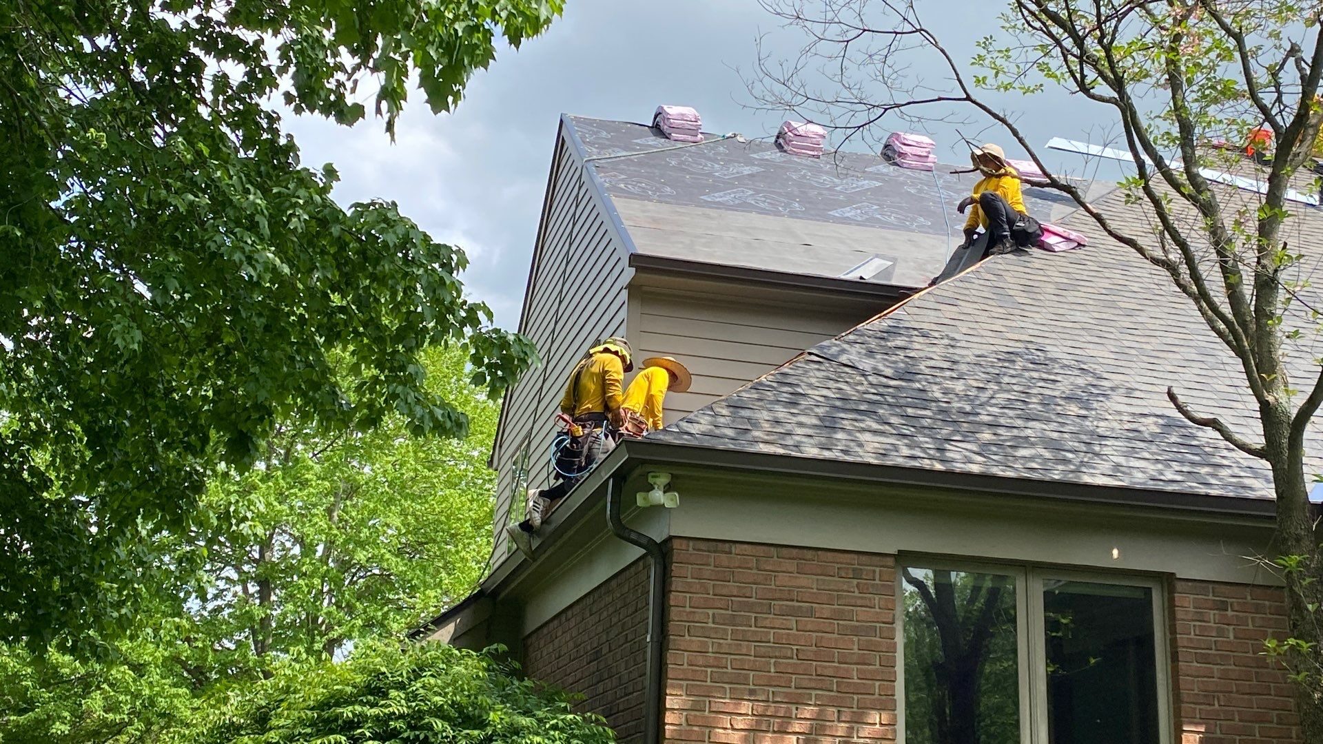 Roofing crew working on a residential roof replacement in Hyde Park neighborhood