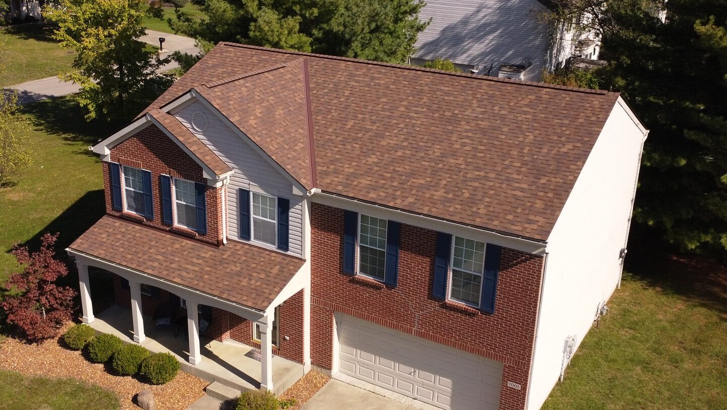 Aerial view of a brown architectural shingle roof on a brick colonial home near Milford, Ohio