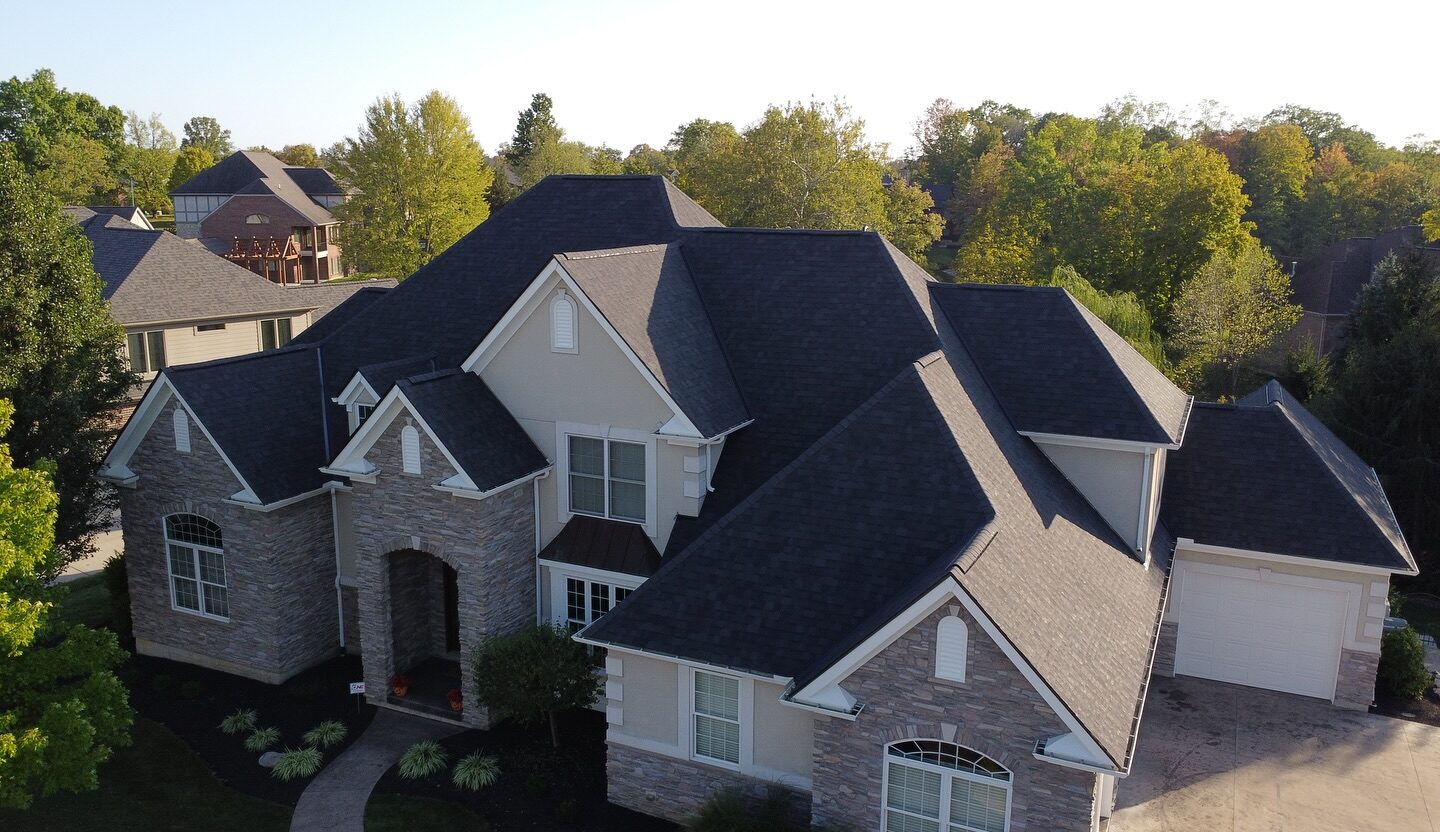 Complex multi-valley roof replacement on a stone-front home in the Milford area