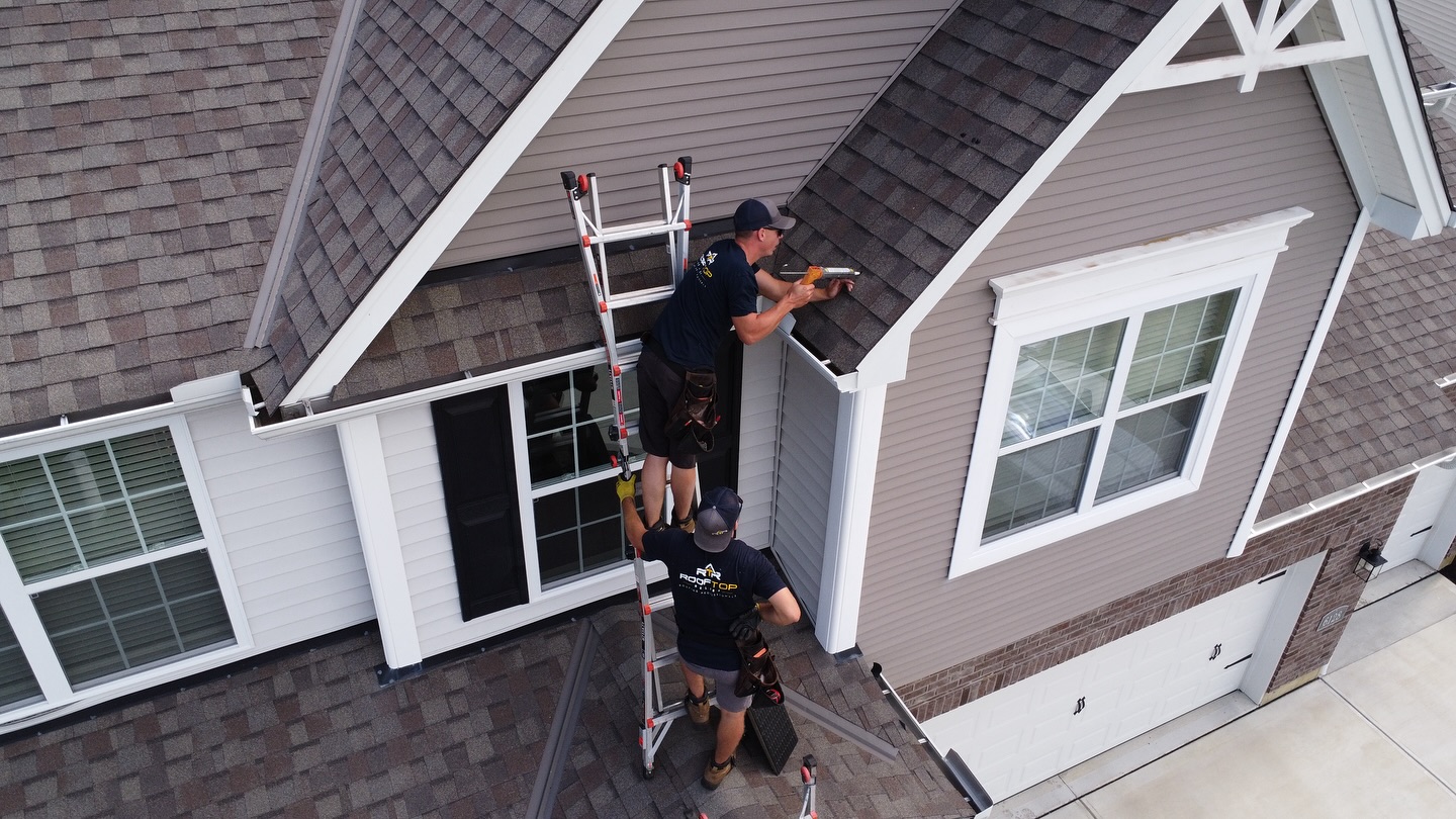 Rooftop Relief crew inspecting a complex roofline on an Indian Hill estate home