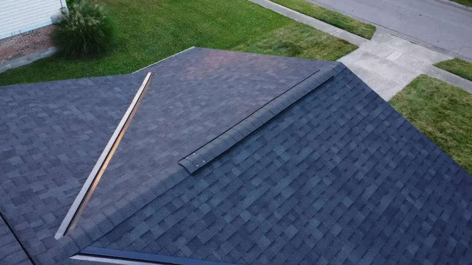 Close aerial view of the ridge line on a new dark architectural shingle roof