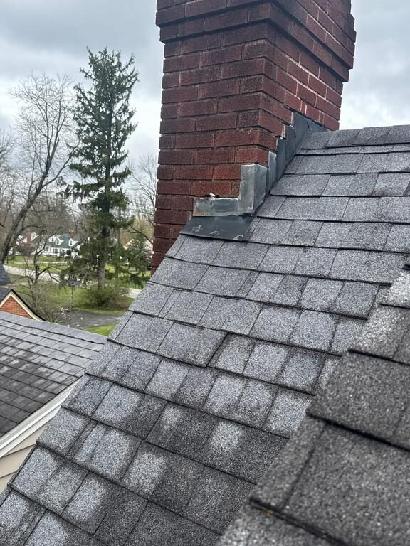 Storm damage to chimney flashing on Cincinnati roof