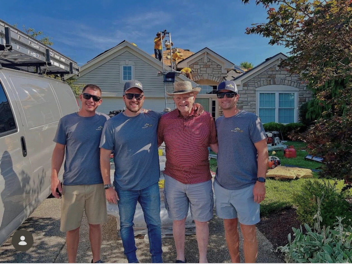 Rooftop Relief Roofing team with a happy customer