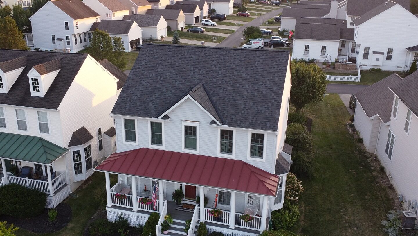 Aerial view of a shingle and standing seam metal porch roof replacement in a West Chester neighborhood