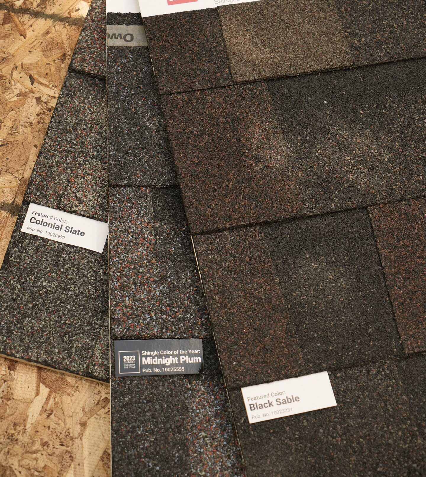 Owens Corning architectural shingle color samples including Colonial Slate, Midnight Plum, and Black Sable